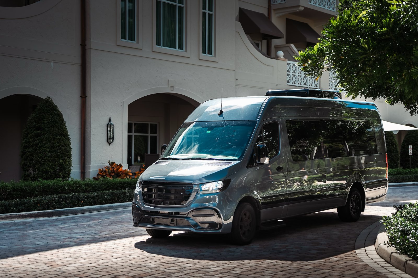 Jet-style Mercedes Sprinter parked outside a hotel