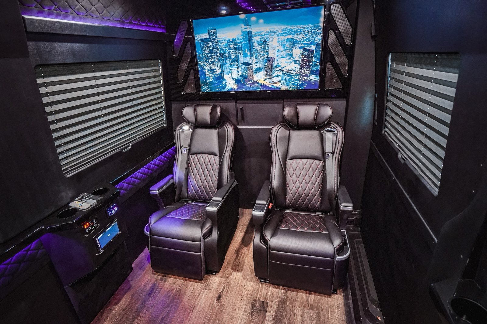 Jet-style Sprinter cabin with two captain chairs and a screen
