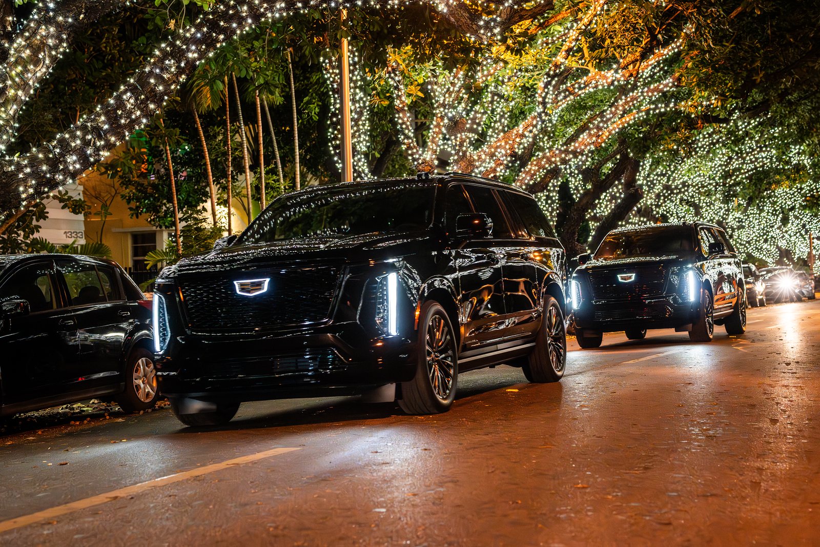 Black Cadillac Escalade chauffeur car at night in Miami